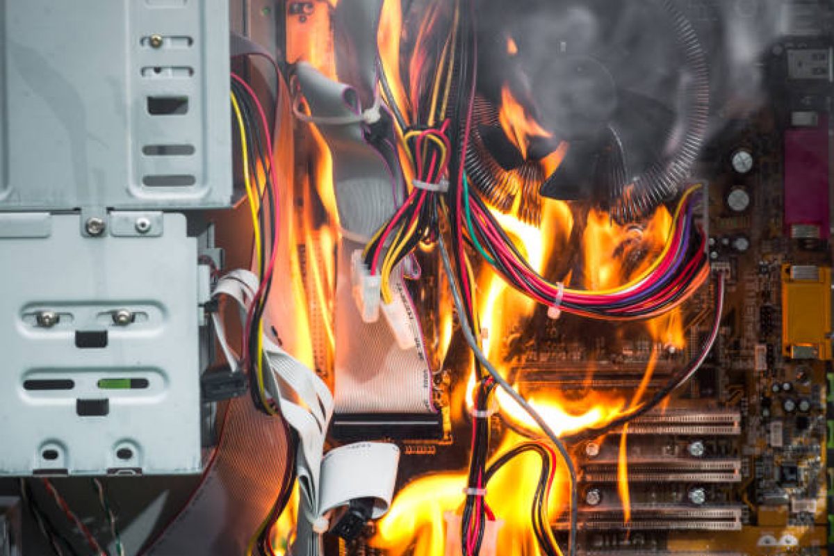 Fire destroying the motherboard and components of a desktop PC.